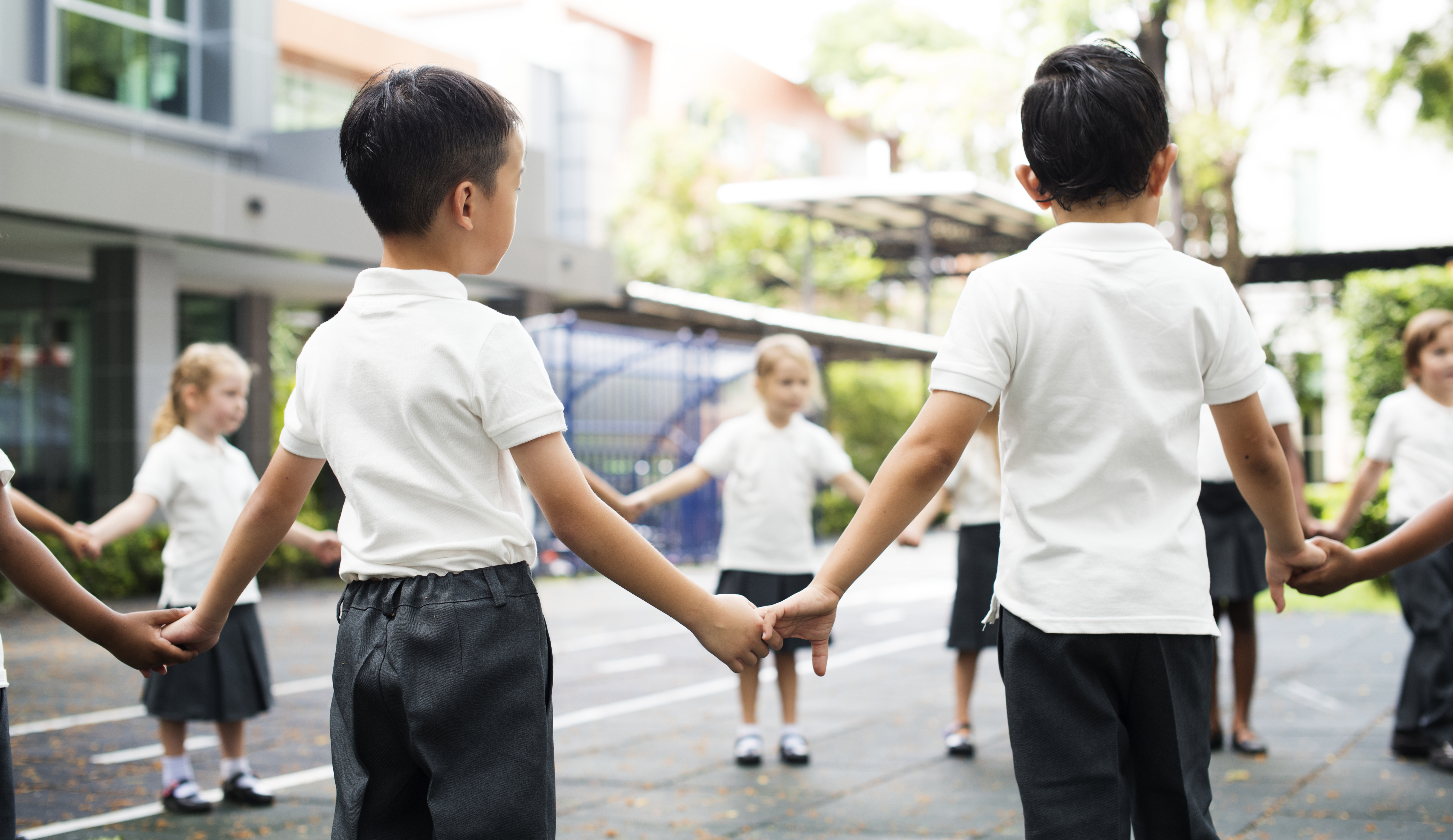 A group of children, looking at a globe.